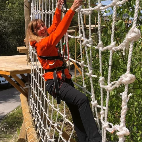 Someone climbing the treetop nets on the sky trek at eden