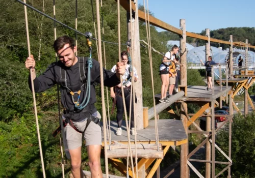 A large group adventuring on sky trek the treetop obstacle course at hangloose eden