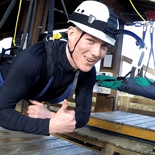 Close up image of a guy ready to zipwire down the hangloose zipline