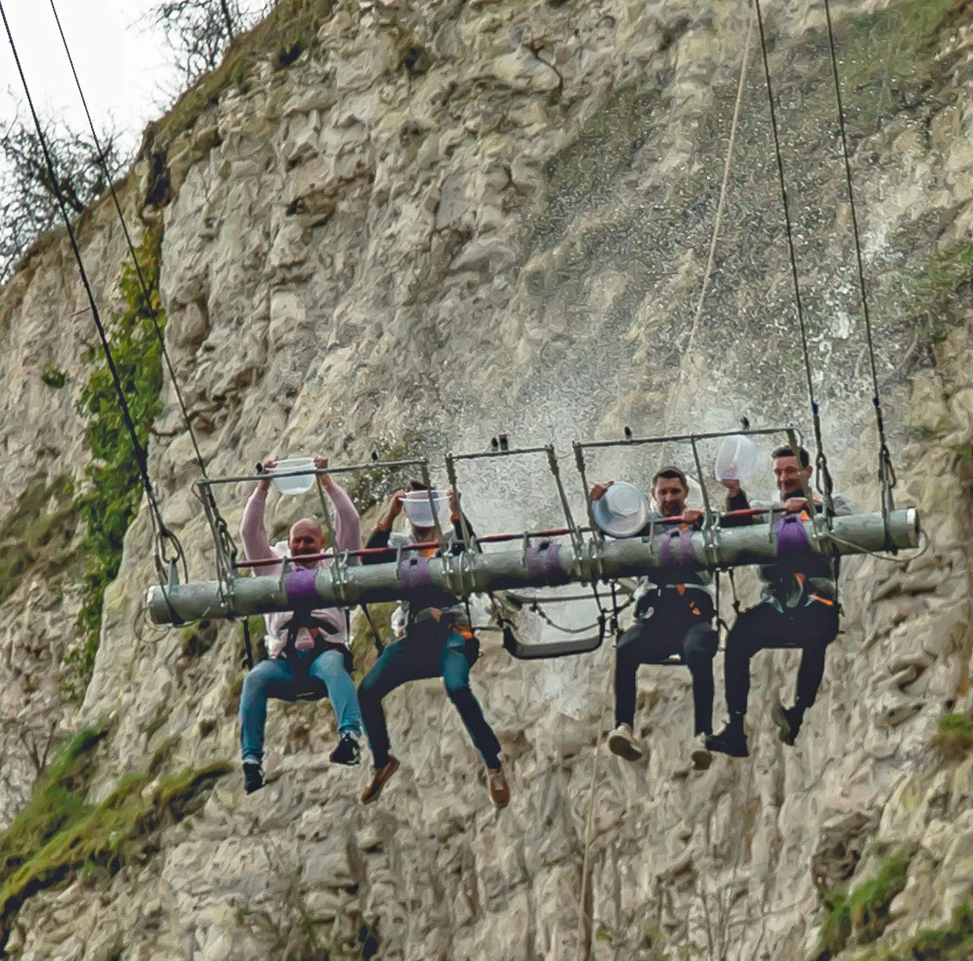 Bluewater Stag do, men on the giant swing holding bowls of water challenge